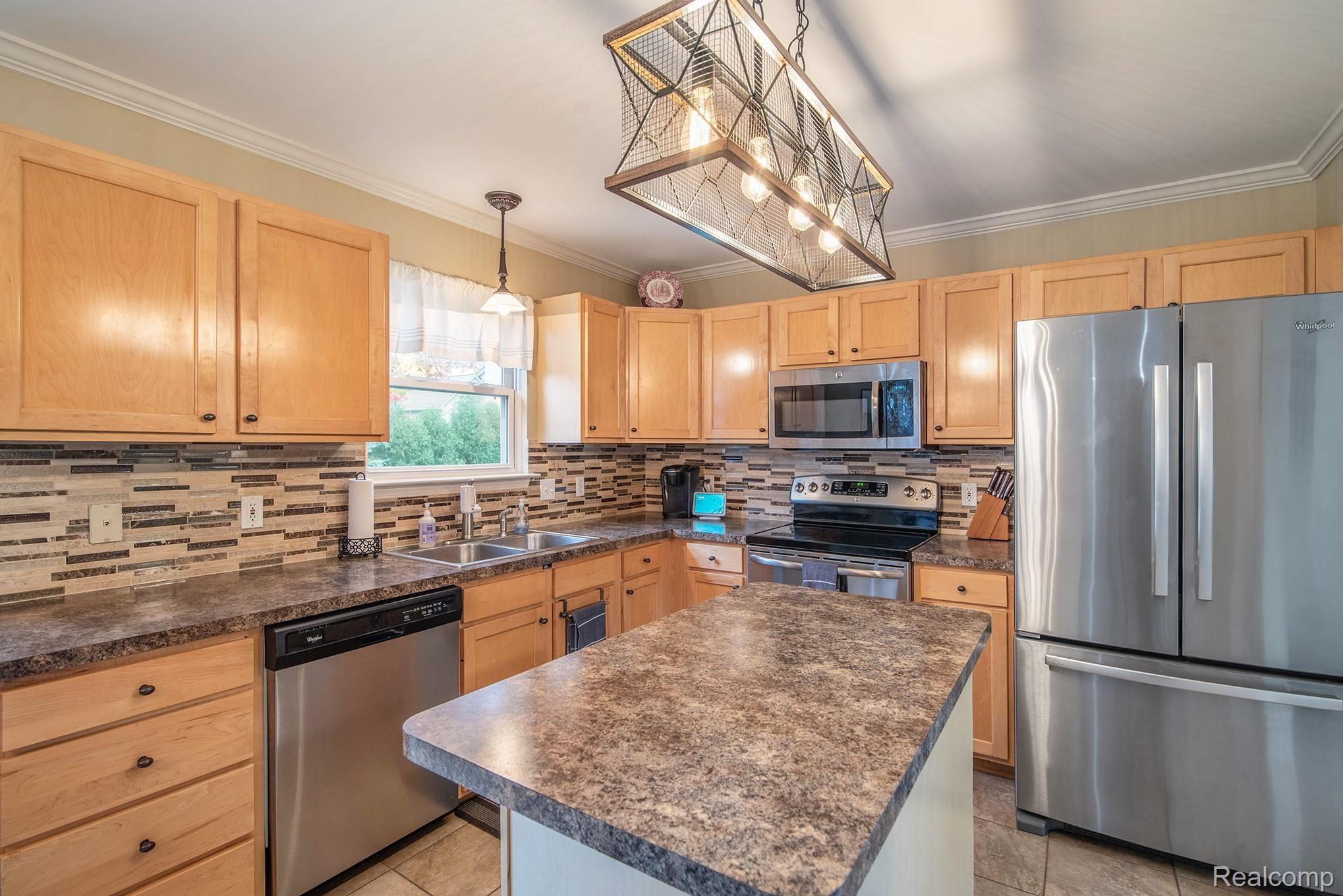 3658 Stratton Lane Howell, MI 48843 - Photo 5 of 23 stainless steel appliances and tile backsplash highlight the kitchen