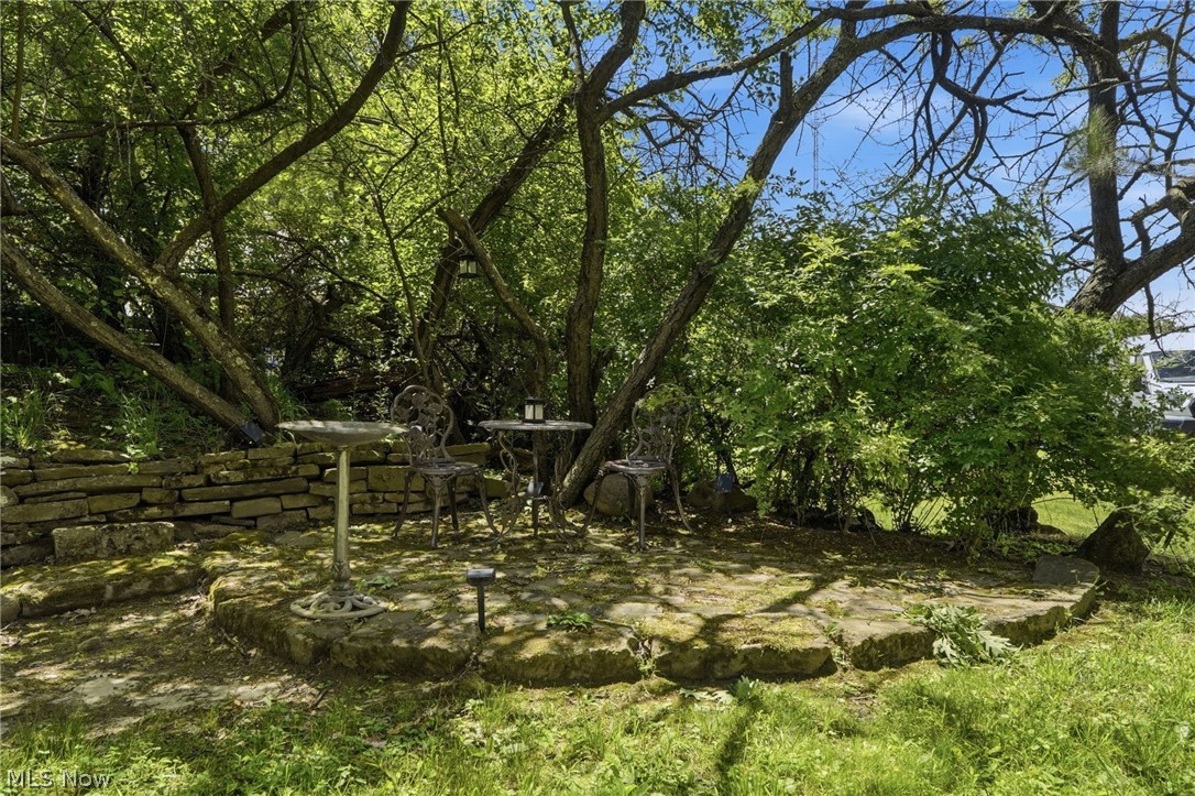 7001 State Road Parma, OH 44134 - Photo 42 of 50 a quaint stone paver patio setting in the shaded backyard