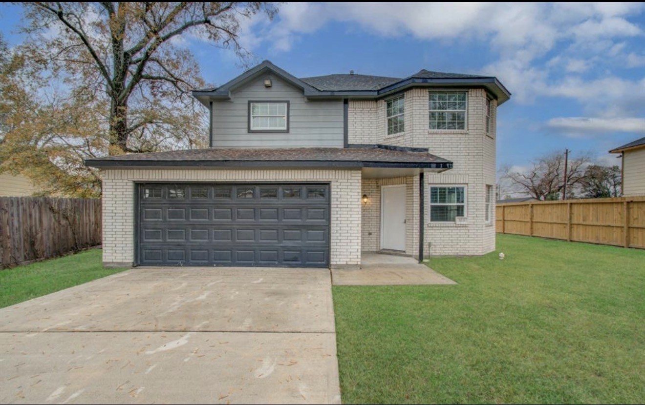 3131 Chaffin Street Houston, TX 77087 - Photo 2 of 11 a front view of a house with a yard and garage
