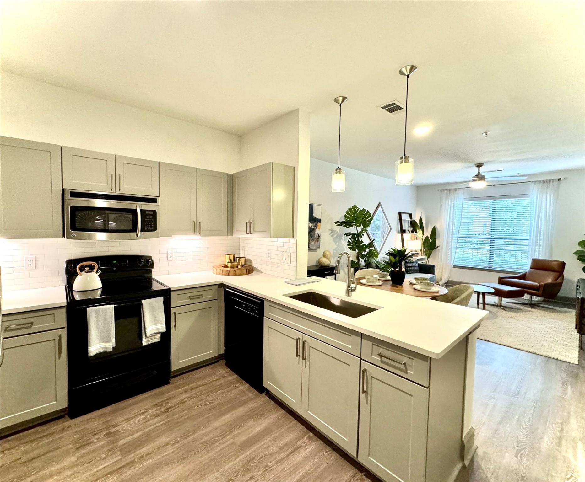 3333 Weslayan Street, Unit 1412 Houston, TX 77027 - Photo 1 of 20 a kitchen with a sink a stove and chairs