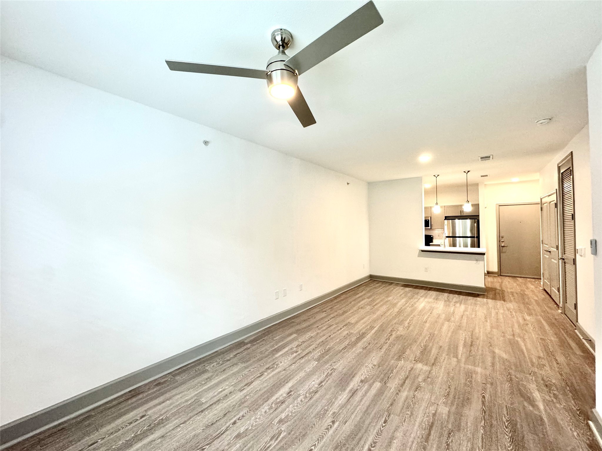 3333 Weslayan Street, Unit 1412 Houston, TX 77027 - Photo 8 of 20 a view of an empty room with wooden floor and a window