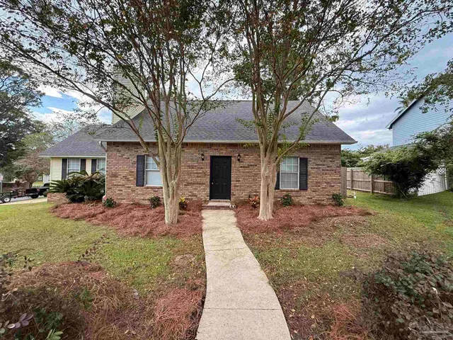 a front view of a house with yard patio and green space