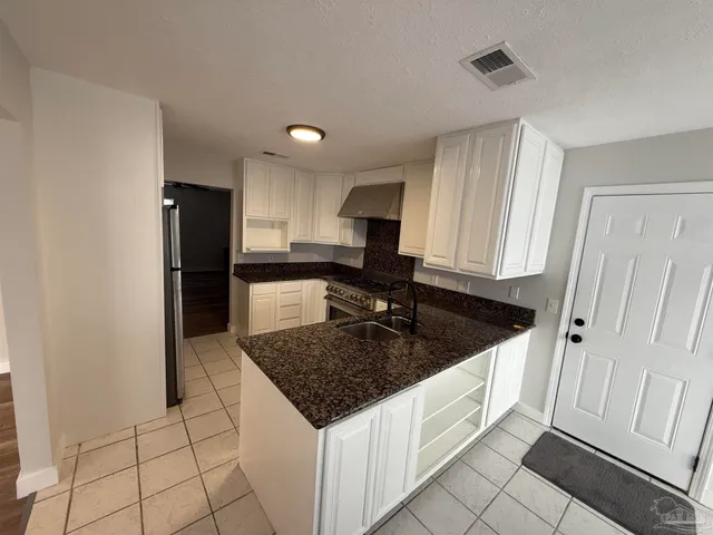 a view of empty room with fireplace and windows