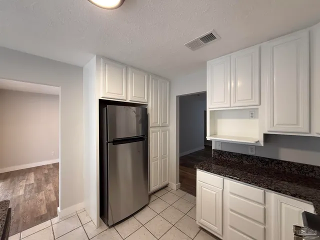 a view of a livingroom with wooden floor and stairs
