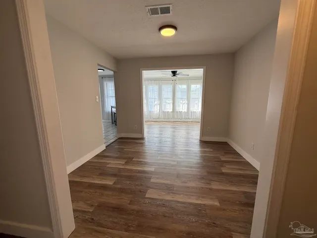 a bathroom with a granite countertop double vanity sink and mirror