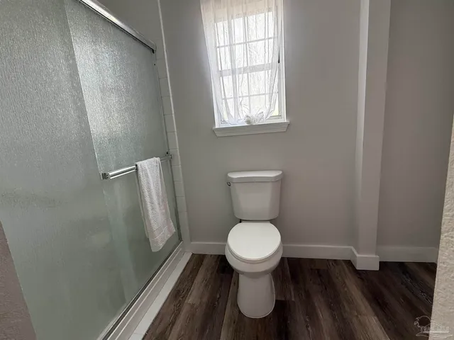 a front view of house with yard and trees around