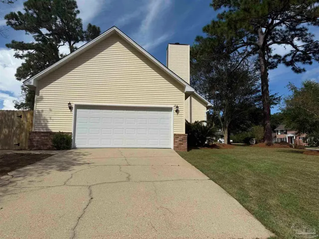 a view of backyard of house along with trees