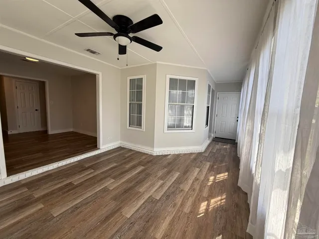 a kitchen with granite countertop a refrigerator and a stove top oven