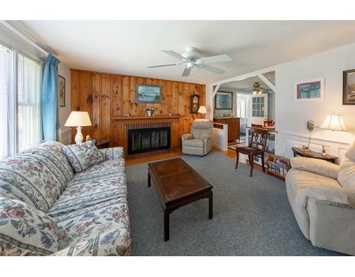 5 Clark Road Bourne, MA 02562 - Photo 8 of 25 a living room with furniture a fireplace and a large window