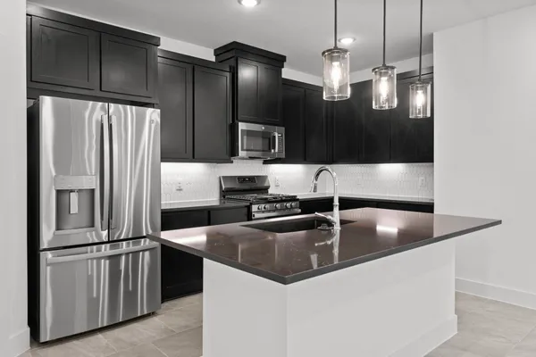an empty room with chandelier fan and windows