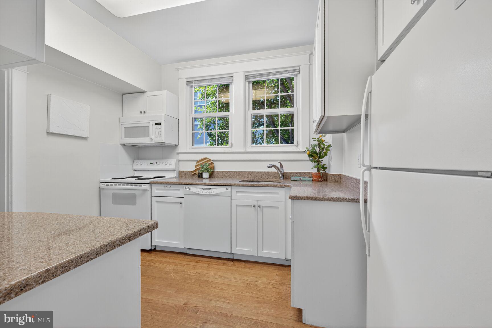 4209 Ellicott Street Northwest Washington, DC 20016 - Photo 12 of 33 a kitchen with stainless steel appliances granite countertop a sink stove and refrigerator