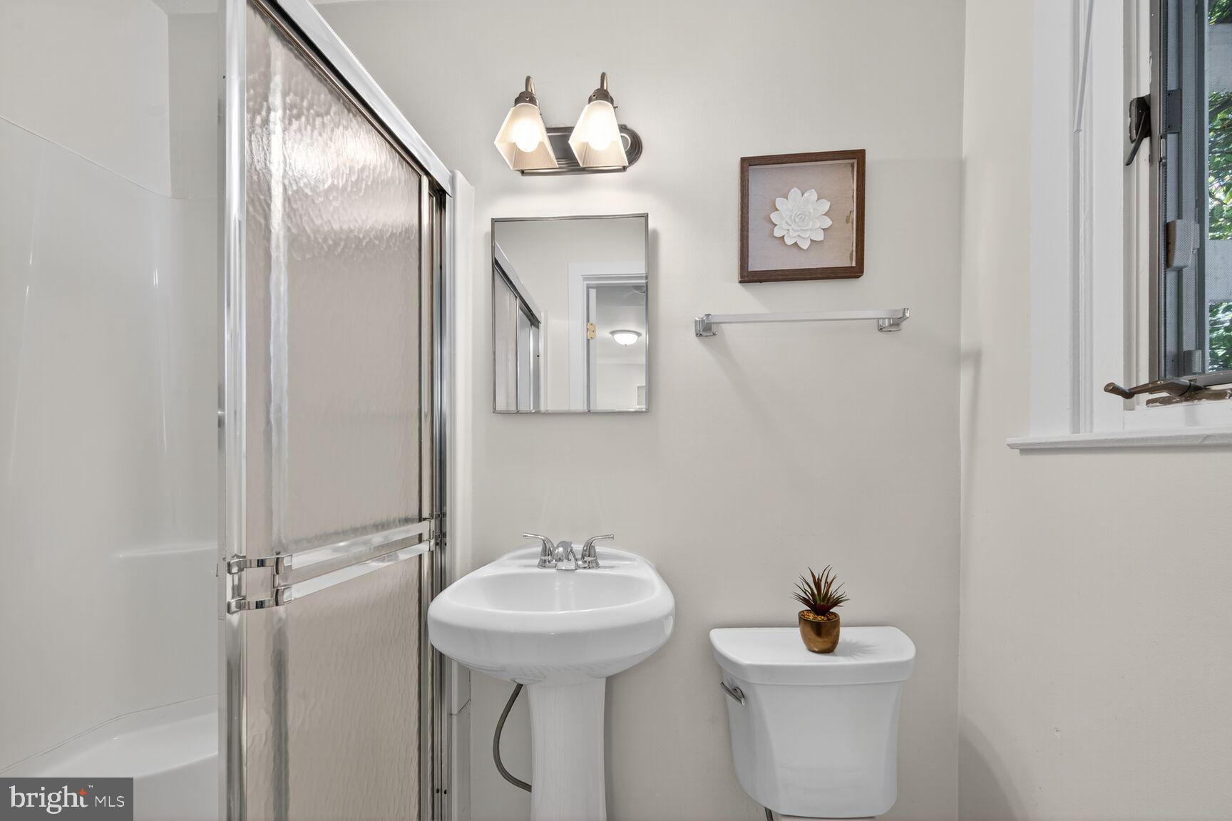 4209 Ellicott Street Northwest Washington, DC 20016 - Photo 17 of 33 a bathroom with a toilet sink and mirror