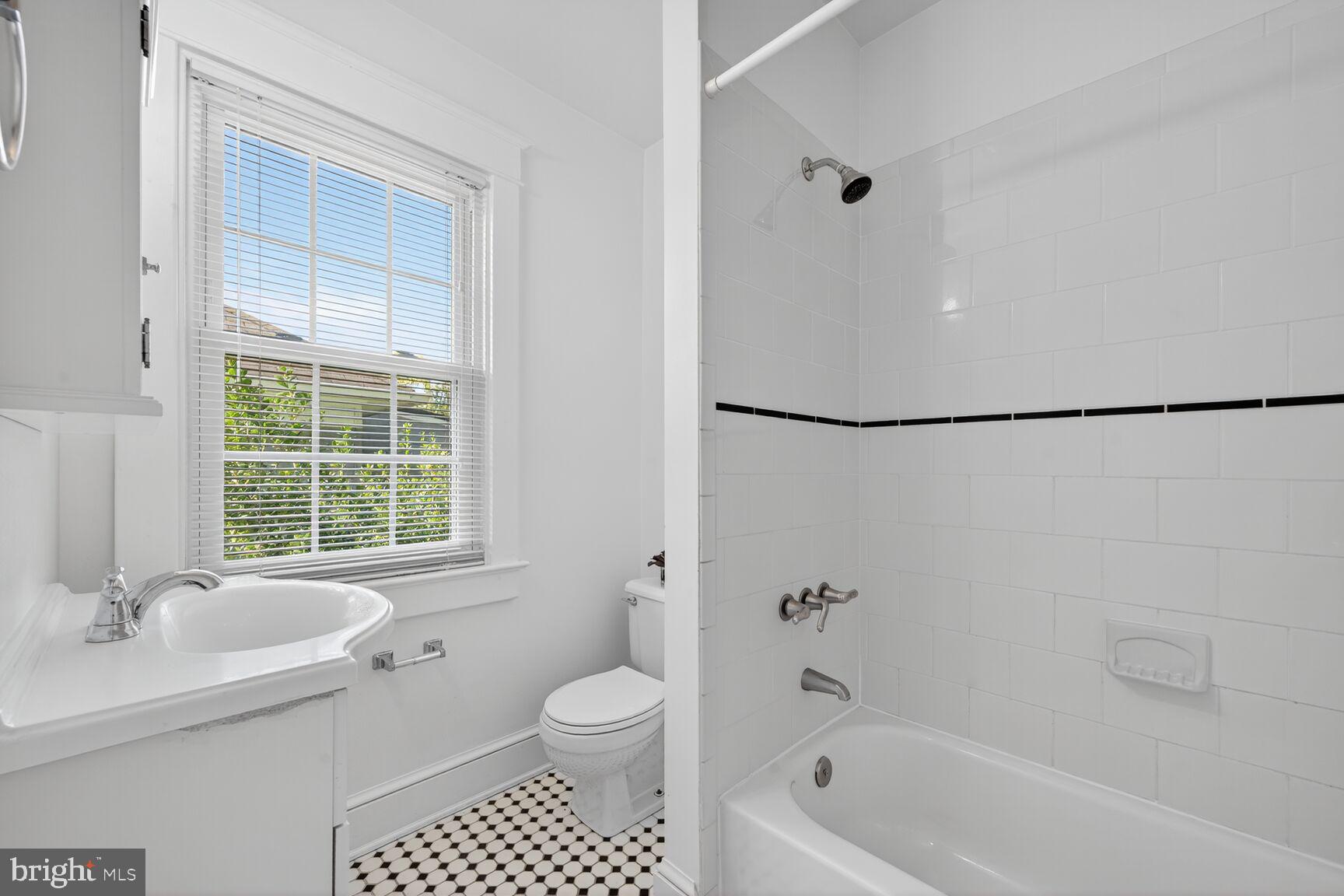 4209 Ellicott Street Northwest Washington, DC 20016 - Photo 19 of 33 a bathroom with a granite countertop sink toilet and shower