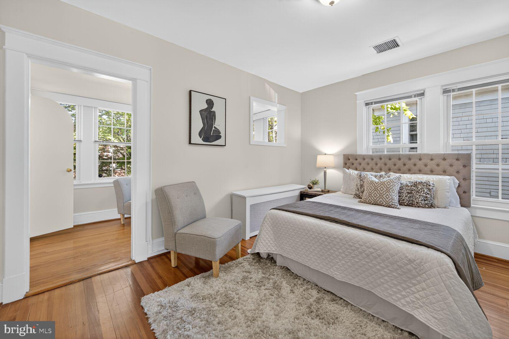 4209 Ellicott Street Northwest Washington, DC 20016 - Photo 20 of 33 a bedroom with a bed and wooden floor