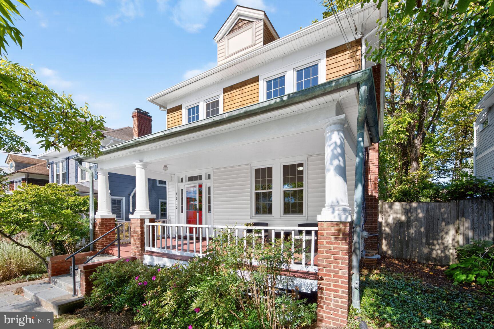 4209 Ellicott Street Northwest Washington, DC 20016 - Photo 2 of 33 front view of a house with a small yard