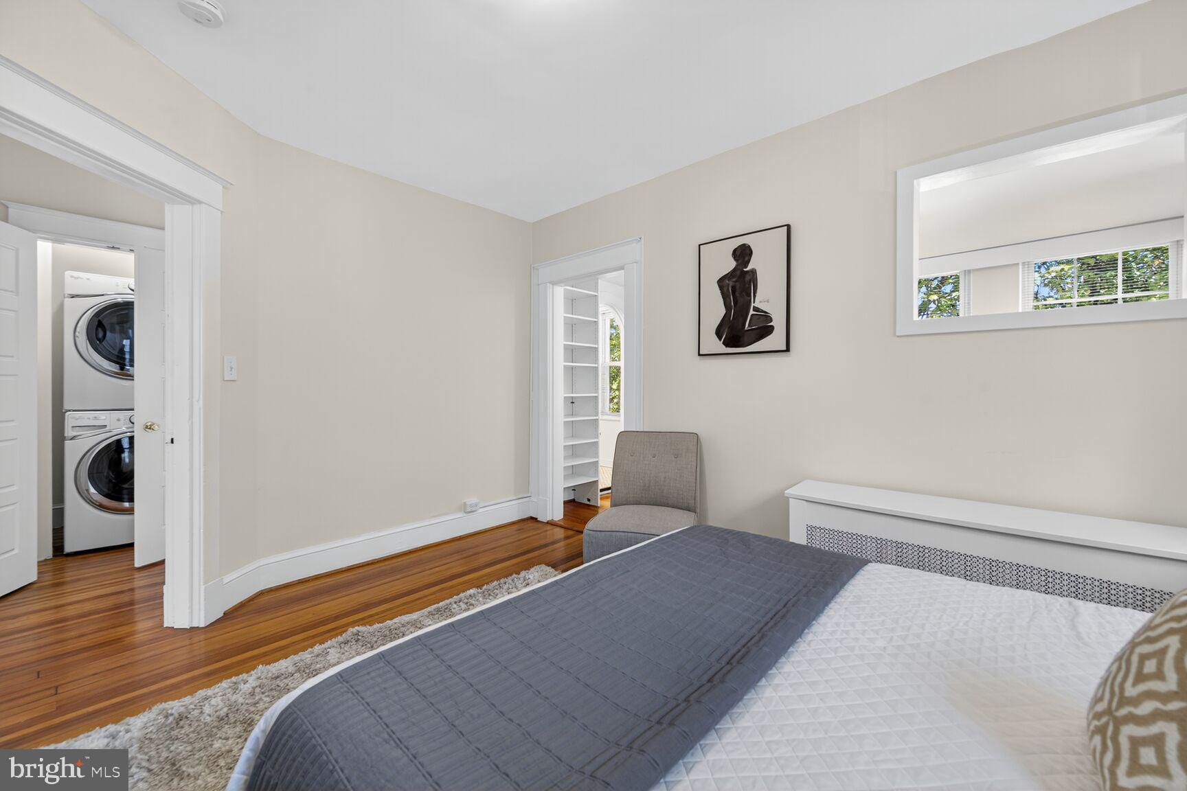 4209 Ellicott Street Northwest Washington, DC 20016 - Photo 26 of 33 a bedroom with a bed and wooden floor