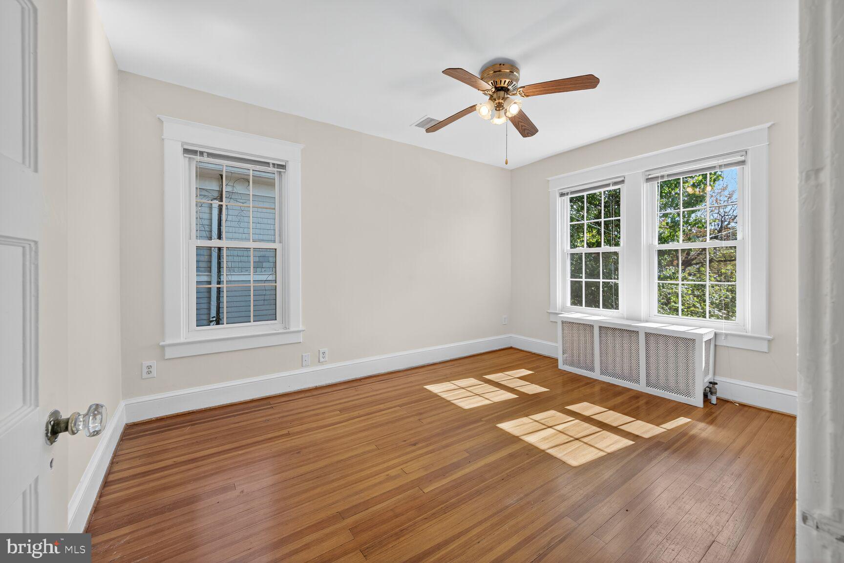 4209 Ellicott Street Northwest Washington, DC 20016 - Photo 27 of 33 a view of an empty room with a window and wooden floor