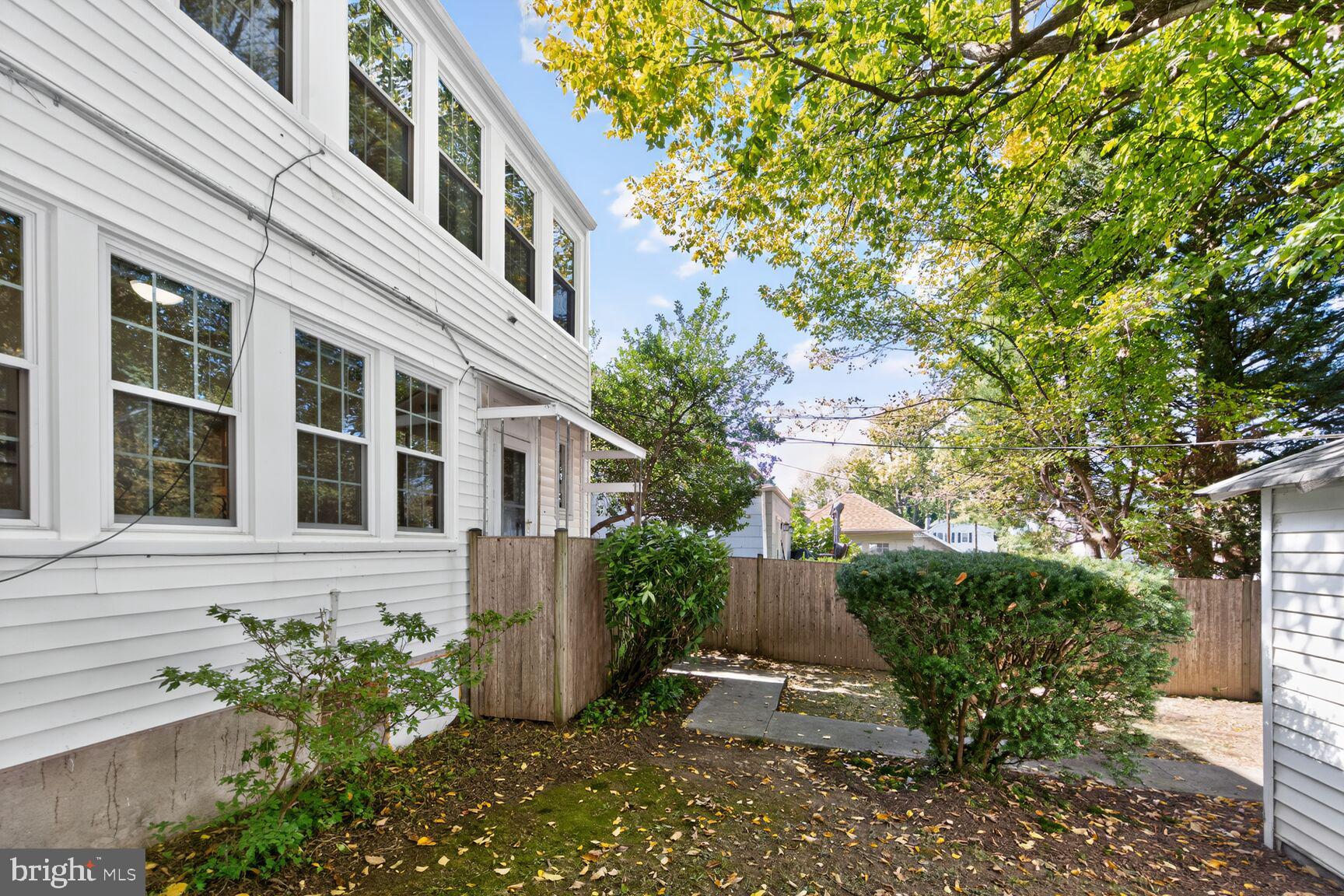 4209 Ellicott Street Northwest Washington, DC 20016 - Photo 33 of 33 a view of a brick house with a flower garden