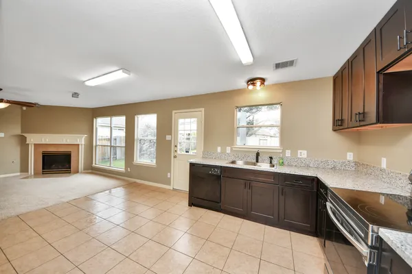 a large white kitchen with a large window