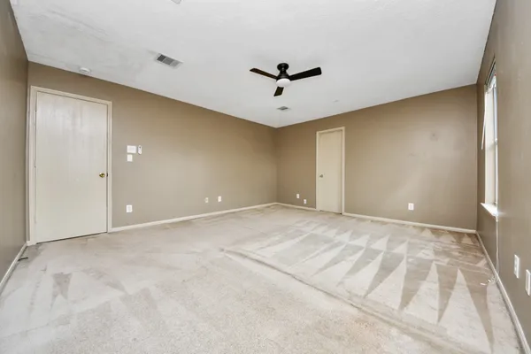 a view of an empty room with a window