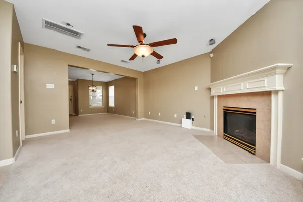 a view of an empty room with a fireplace