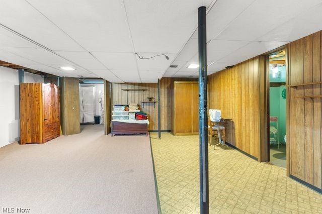 815 North Road Niles, OH 44446 - Photo 24 of 27 Basement with light colored carpet, wooden walls, and a paneled ceiling