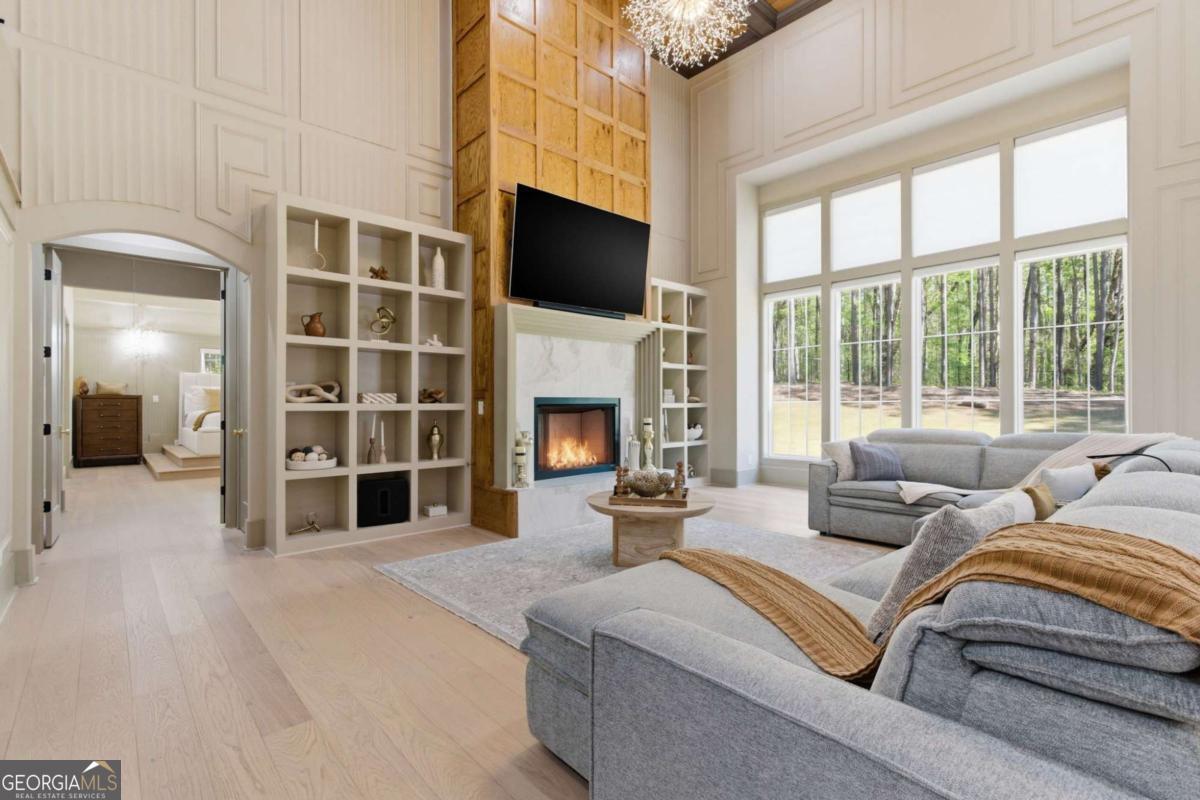 1315 Sandy Creek Road Tyrone, GA 30290 - Photo 23 of 100 a living room with furniture a fireplace and a flat screen tv