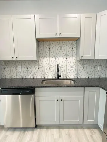a kitchen with a sink and cabinets