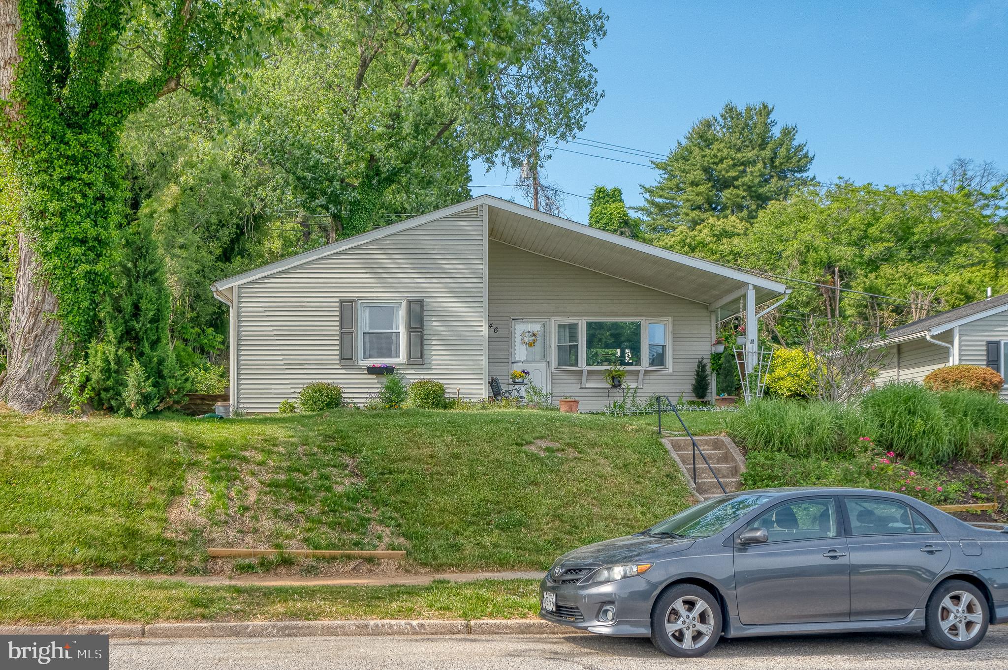 a front view of a house with a garden