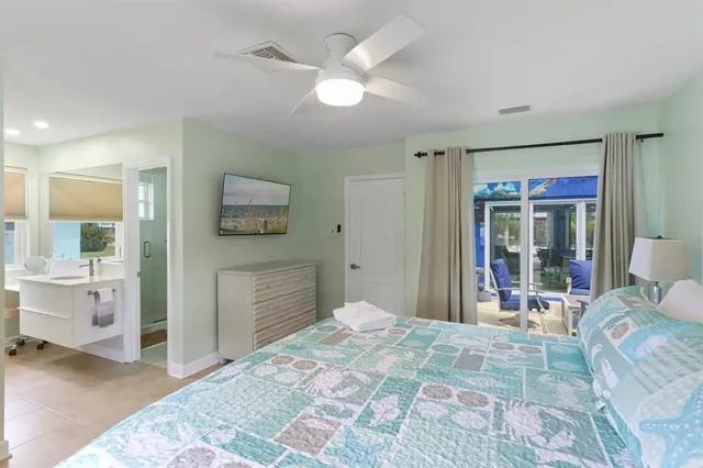 a bedroom with a bed and a large window