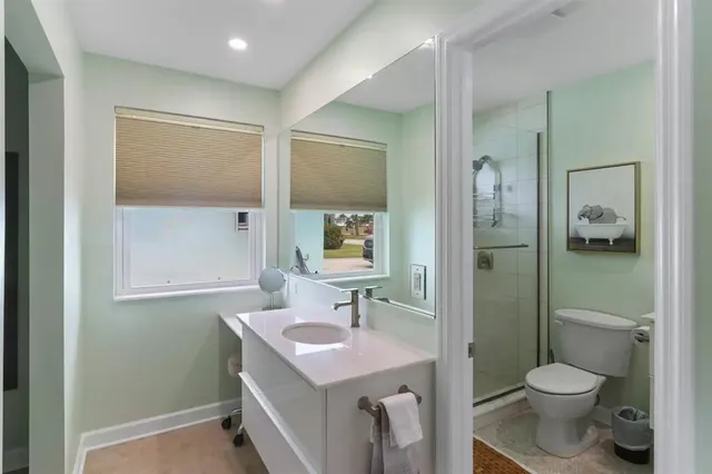 a bathroom with a toilet sink shower and mirror