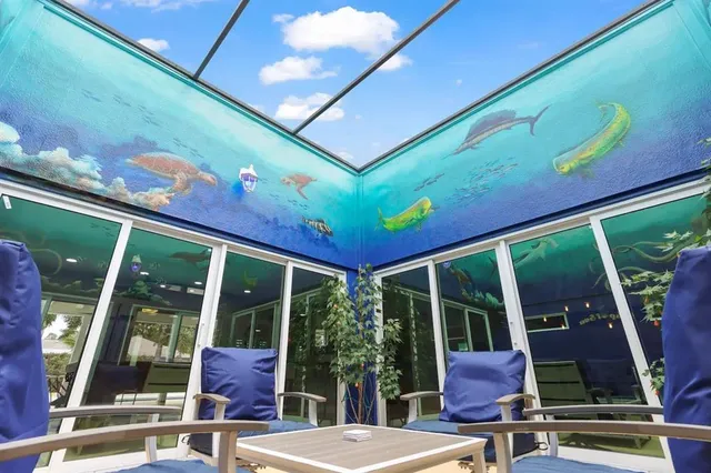 a view of a patio with table and chairs and potted plants