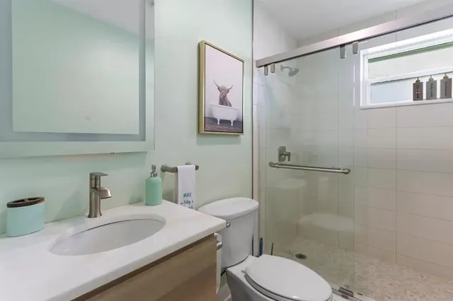 a bathroom with a sink toilet and shower