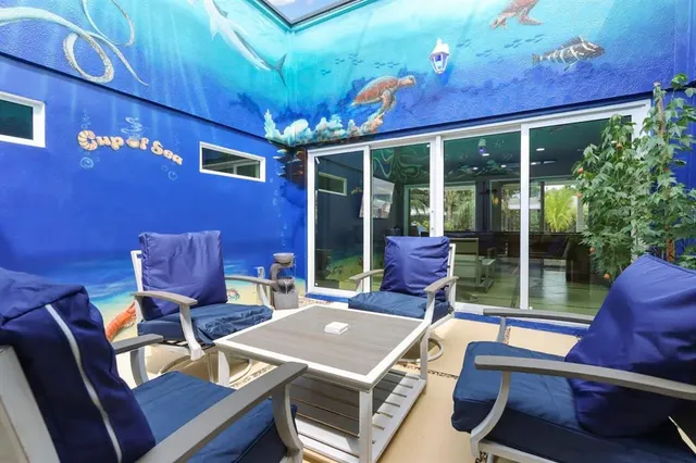a view of a patio with table and chairs and potted plants