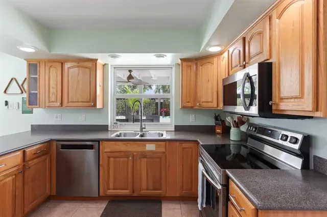 a kitchen with a stove a sink and a microwave