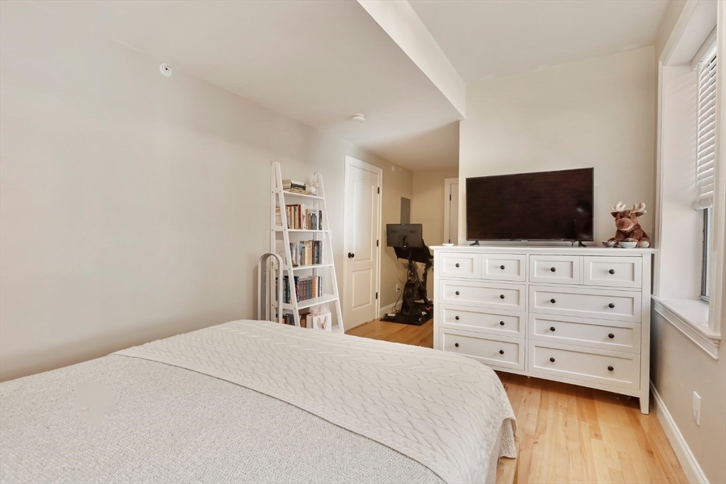 454 Hanover Street, Unit 4 Boston, MA 02113 - Photo 13 of 23 a bedroom with a bed and a flat screen tv