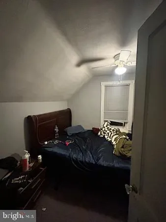 a bedroom with furniture and a lamp