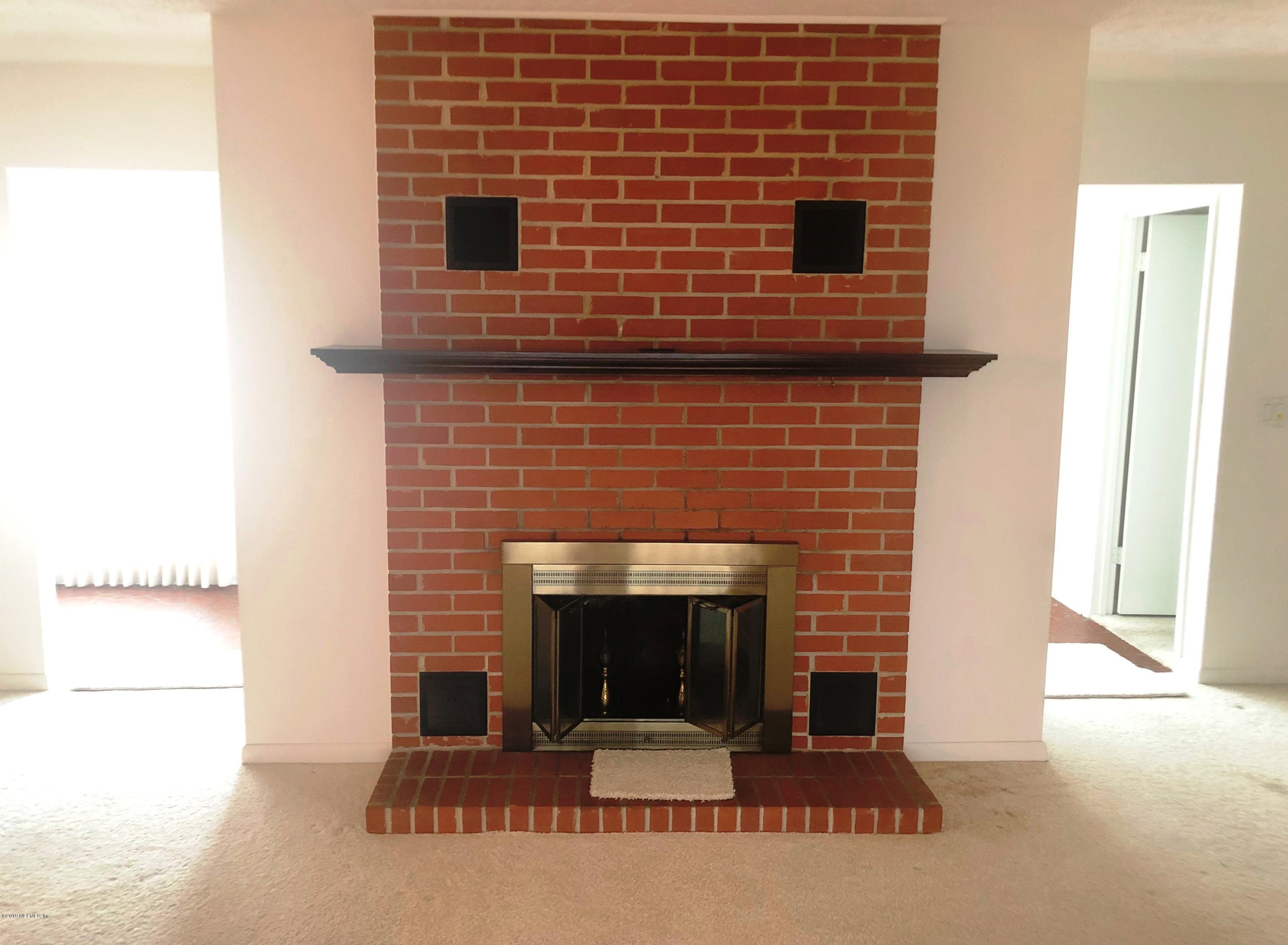 730 North Park Street Crescent City, FL 32112 - Photo 11 of 31 a brick oven with a fireplace