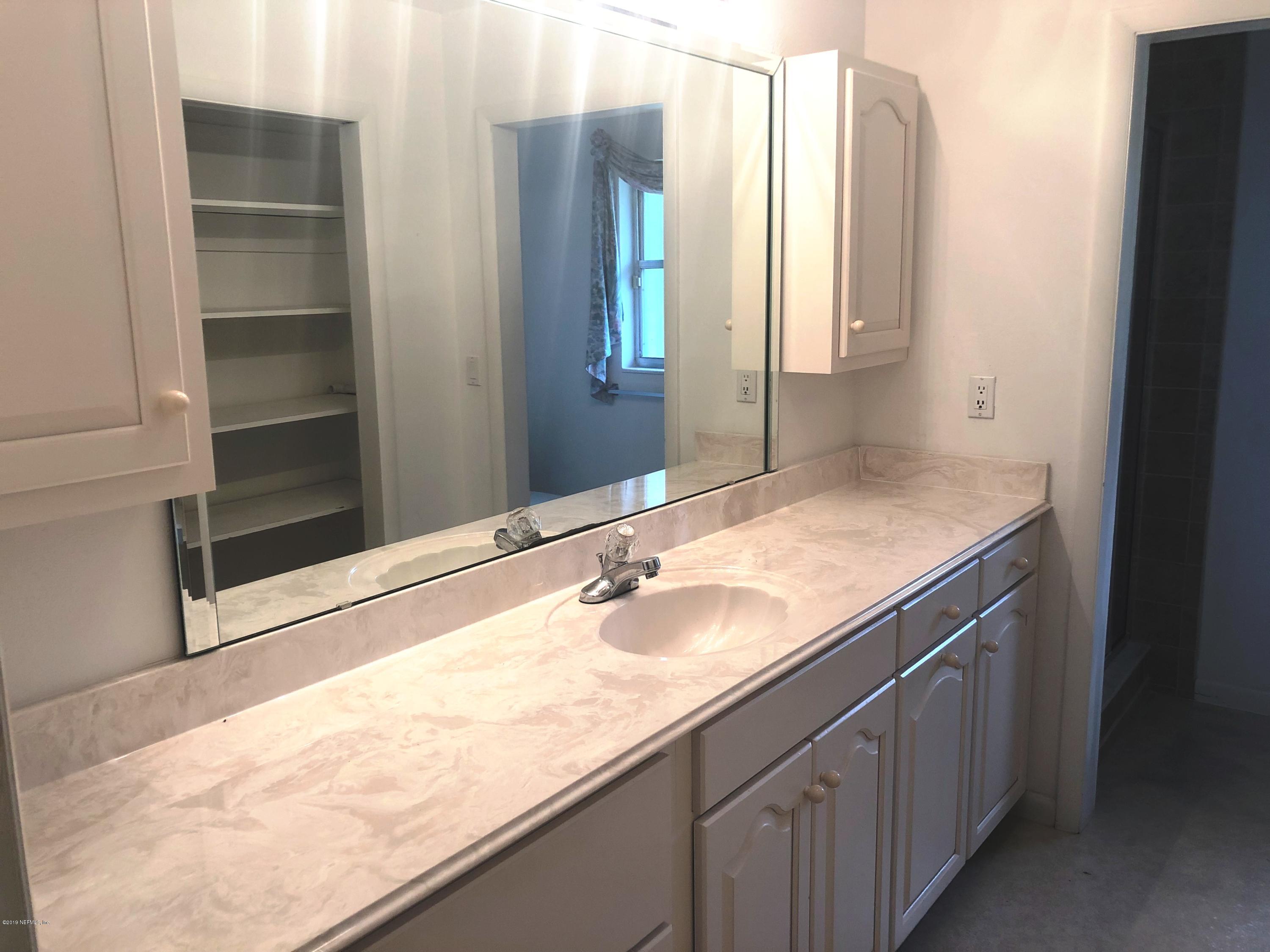 730 North Park Street Crescent City, FL 32112 - Photo 19 of 31 a bathroom with a sink and a mirror