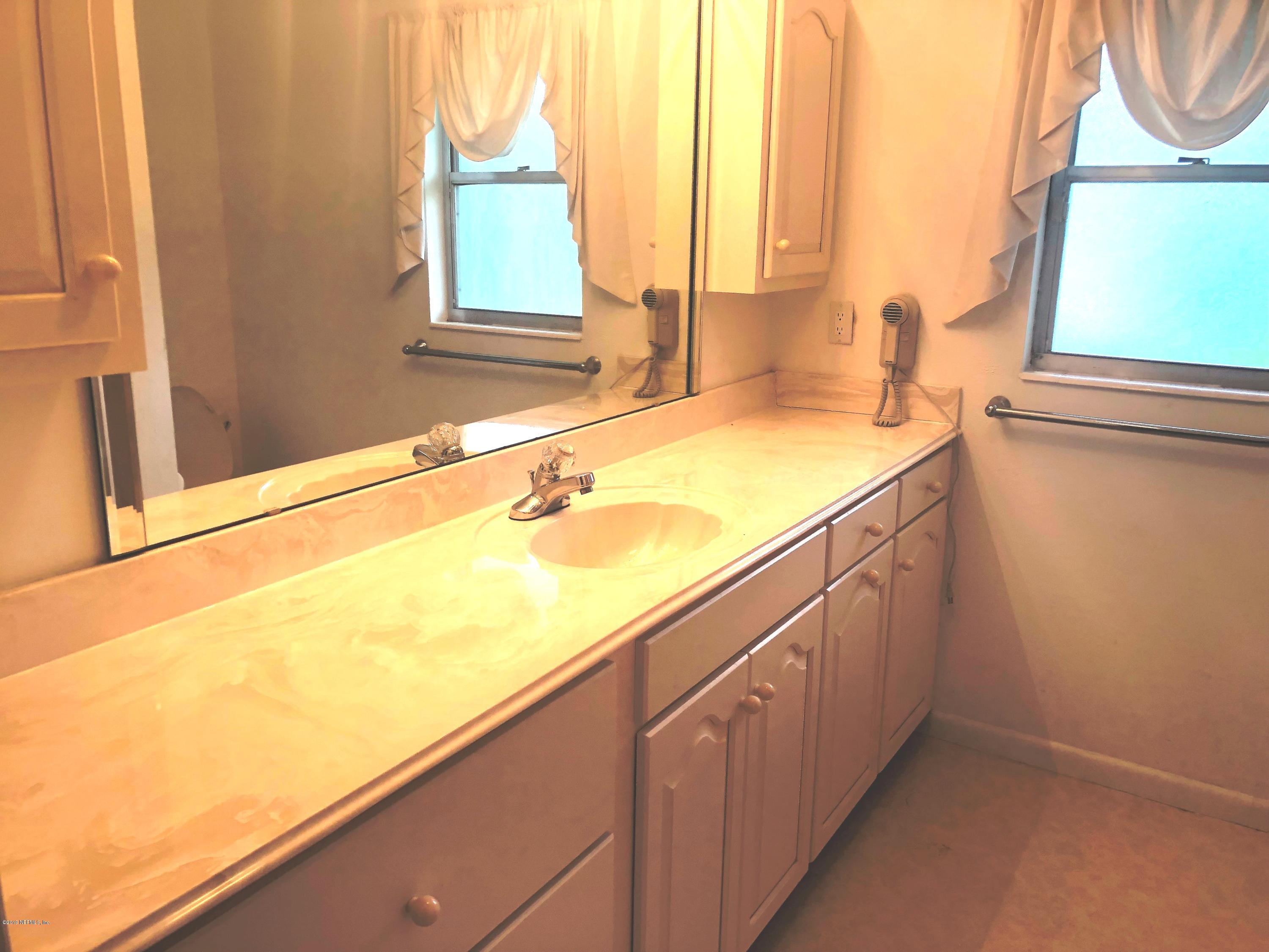 730 North Park Street Crescent City, FL 32112 - Photo 23 of 31 a bathroom with a sink and a window