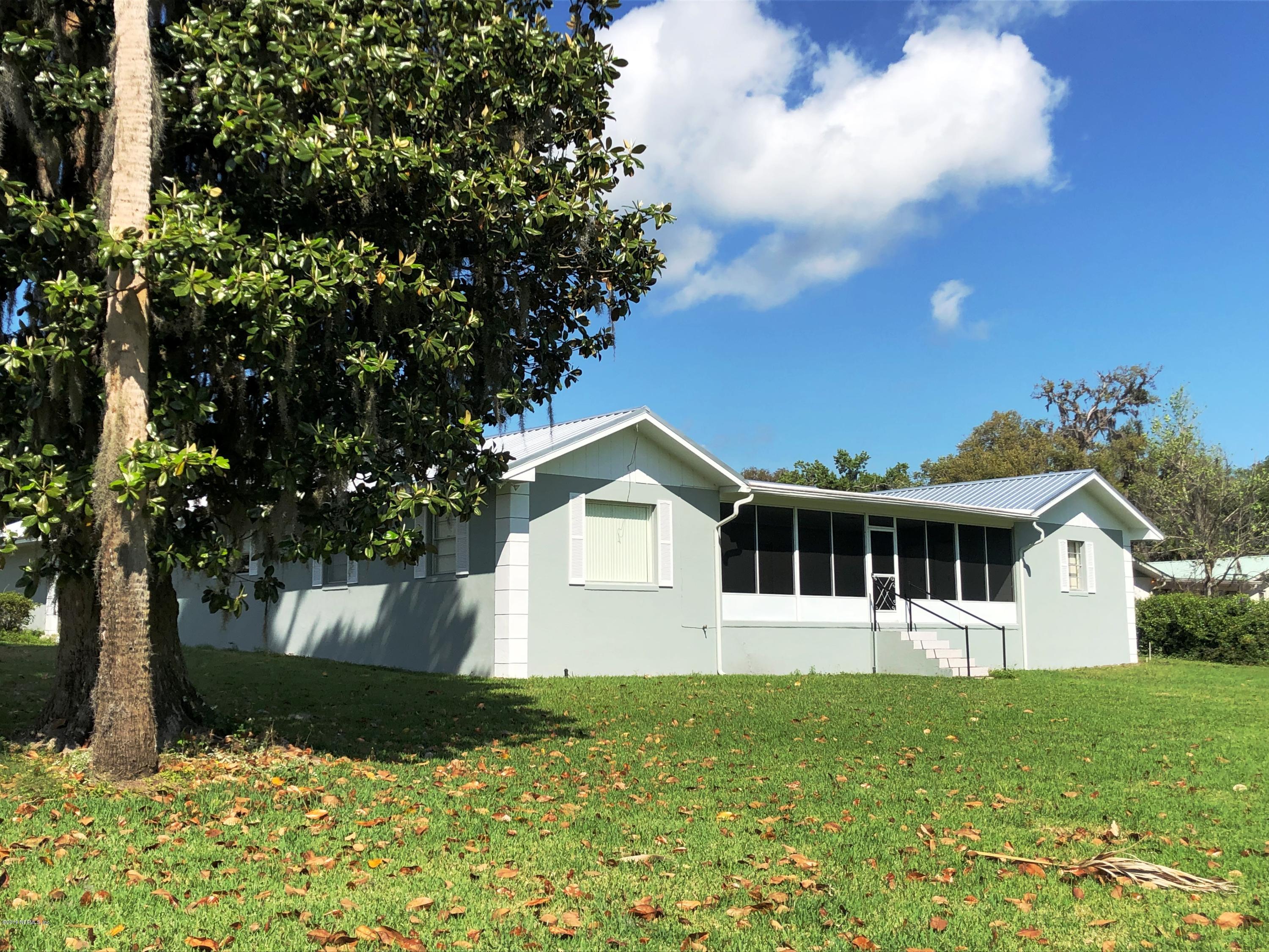 730 North Park Street Crescent City, FL 32112 - Photo 3 of 31 a front view of a house with a garden