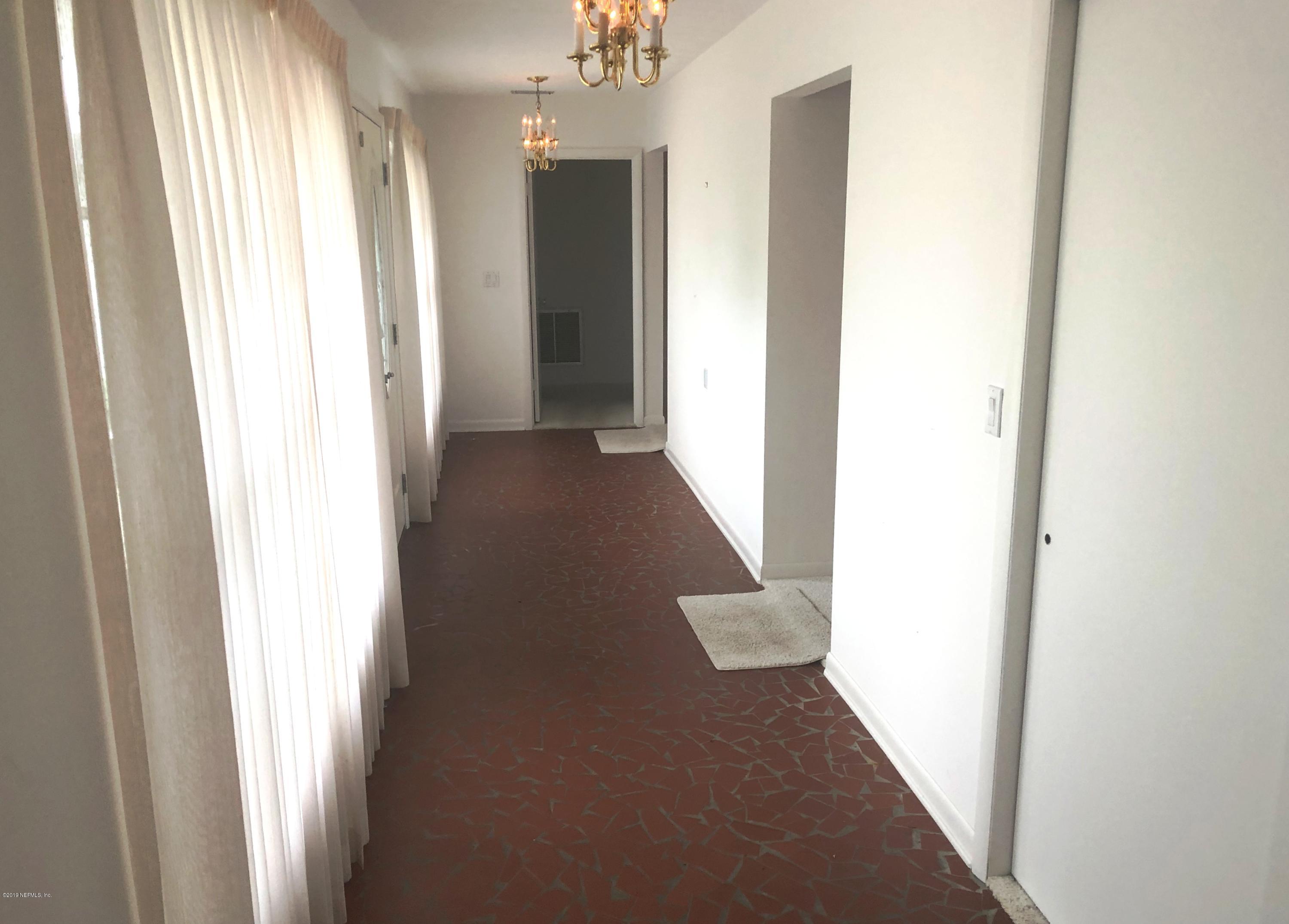 730 North Park Street Crescent City, FL 32112 - Photo 8 of 31 a view of a hallway with wooden floor and staircase