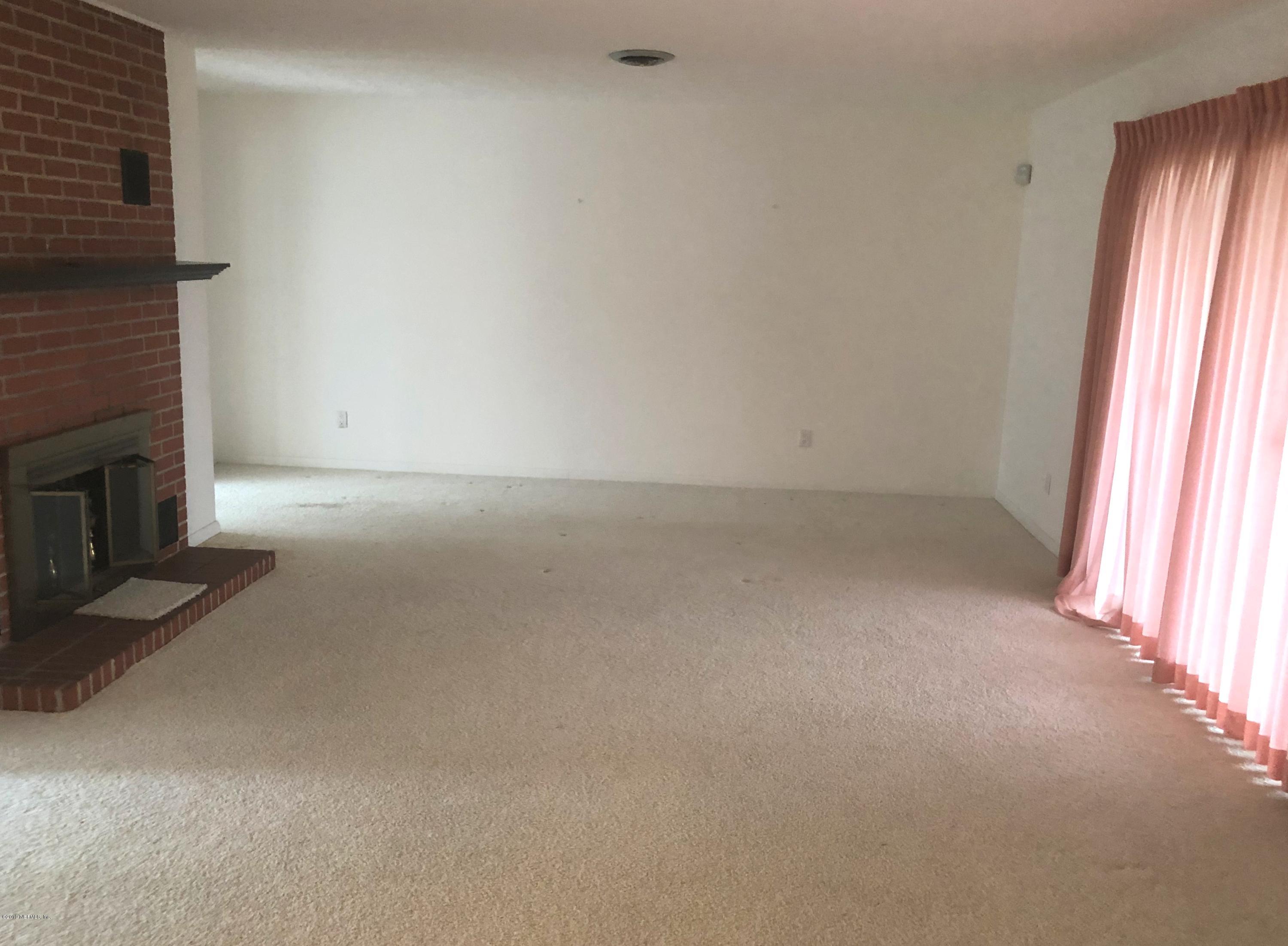 730 North Park Street Crescent City, FL 32112 - Photo 9 of 31 a view of empty room with window and fireplace