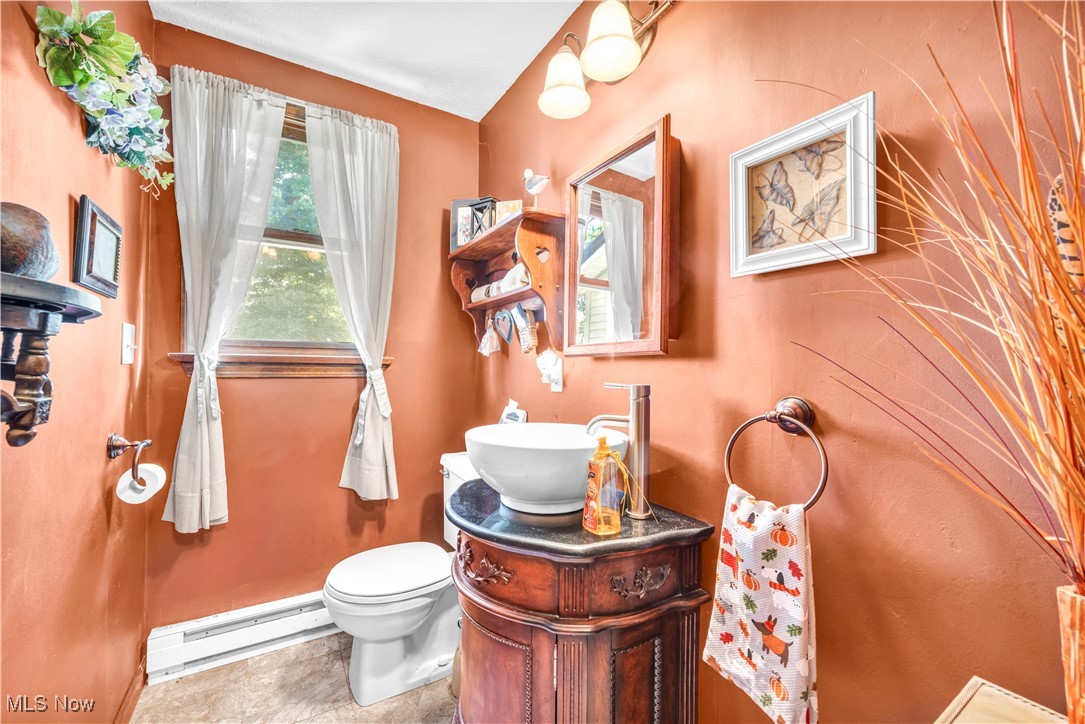 4032 Hanford Road Wakeman, OH 44889 - Photo 9 of 50 Bathroom with toilet, a baseboard heating unit, and vanity