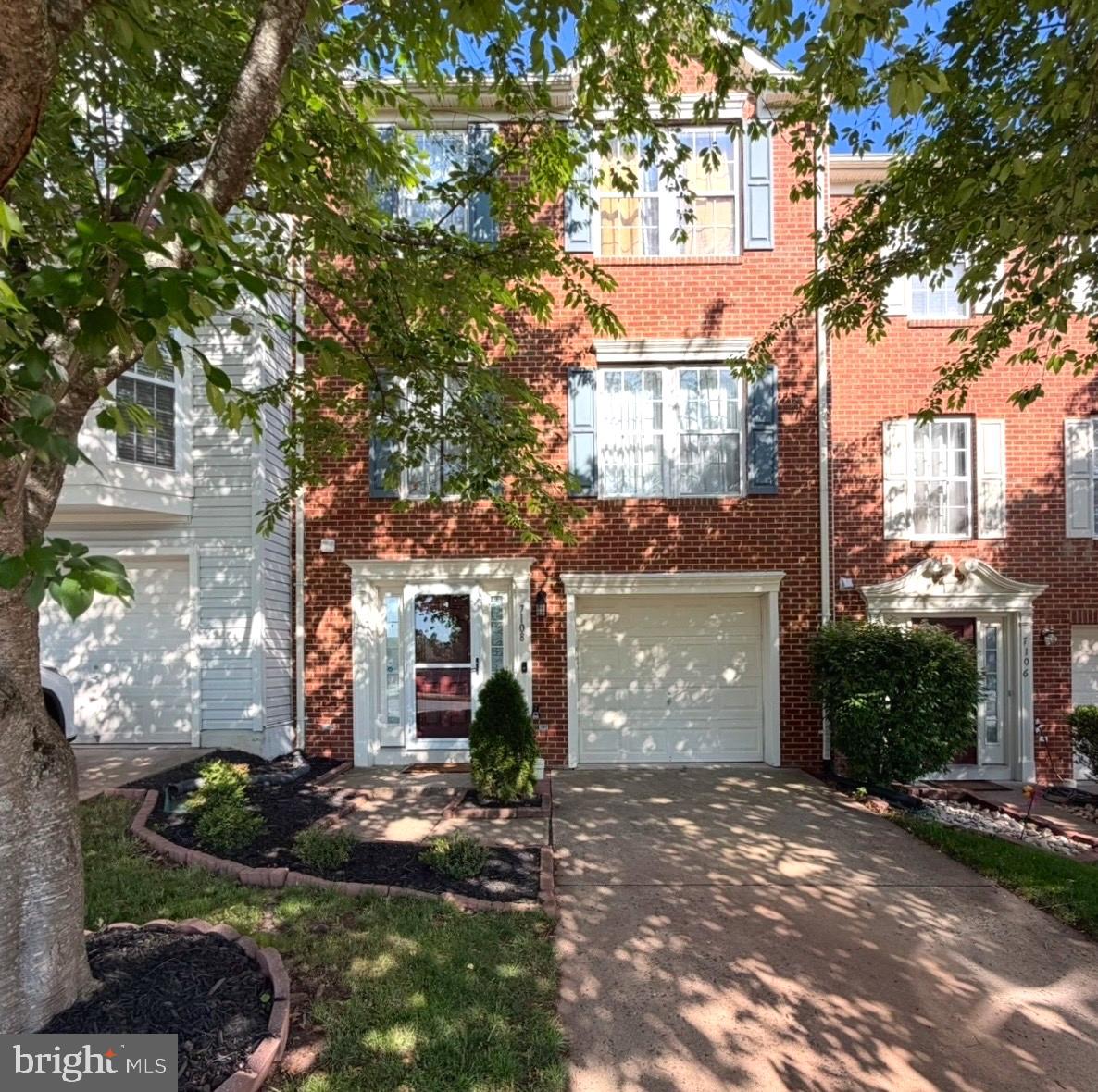 7108 Wheeling Way Gainesville, VA 20155 - Photo 2 of 45 a front view of a house with garden