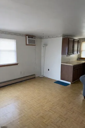 a view of a livingroom with wooden floor and a balcony