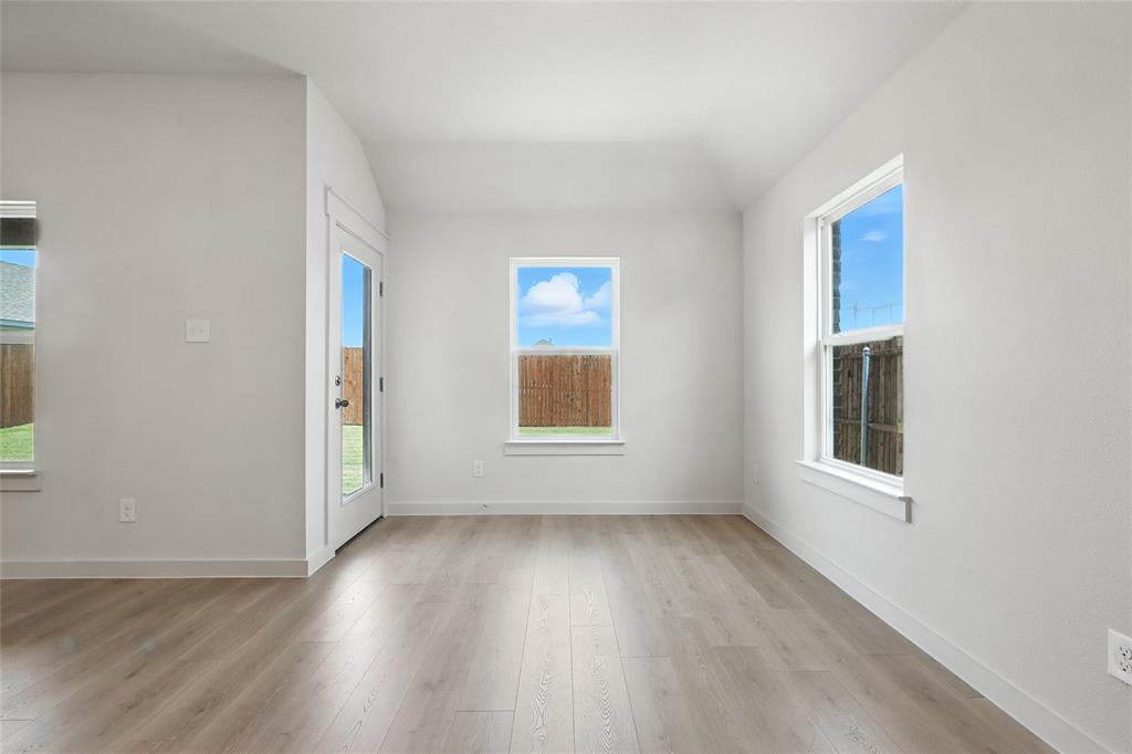 1795 Gleasondale Place Forney, TX 75126 - Photo 6 of 29 Unfurnished room with light wood-style floors and vaulted ceiling