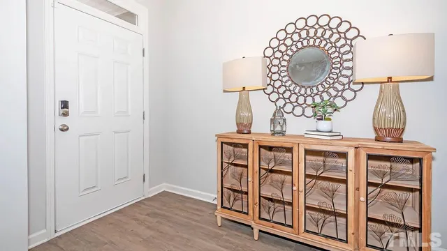 an empty room with wooden floor and white walls