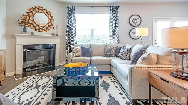 a living room with furniture a fireplace and window