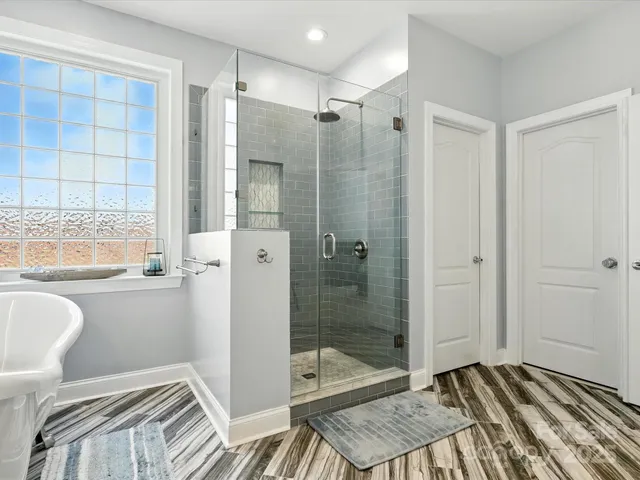 a bathroom with a granite countertop sink toilet mirror and shower